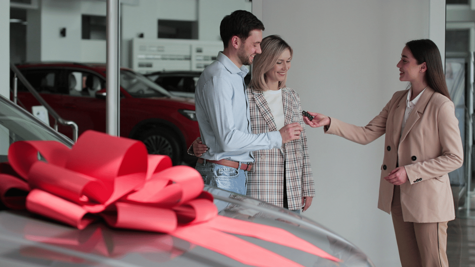 Man and woman being handed car keys