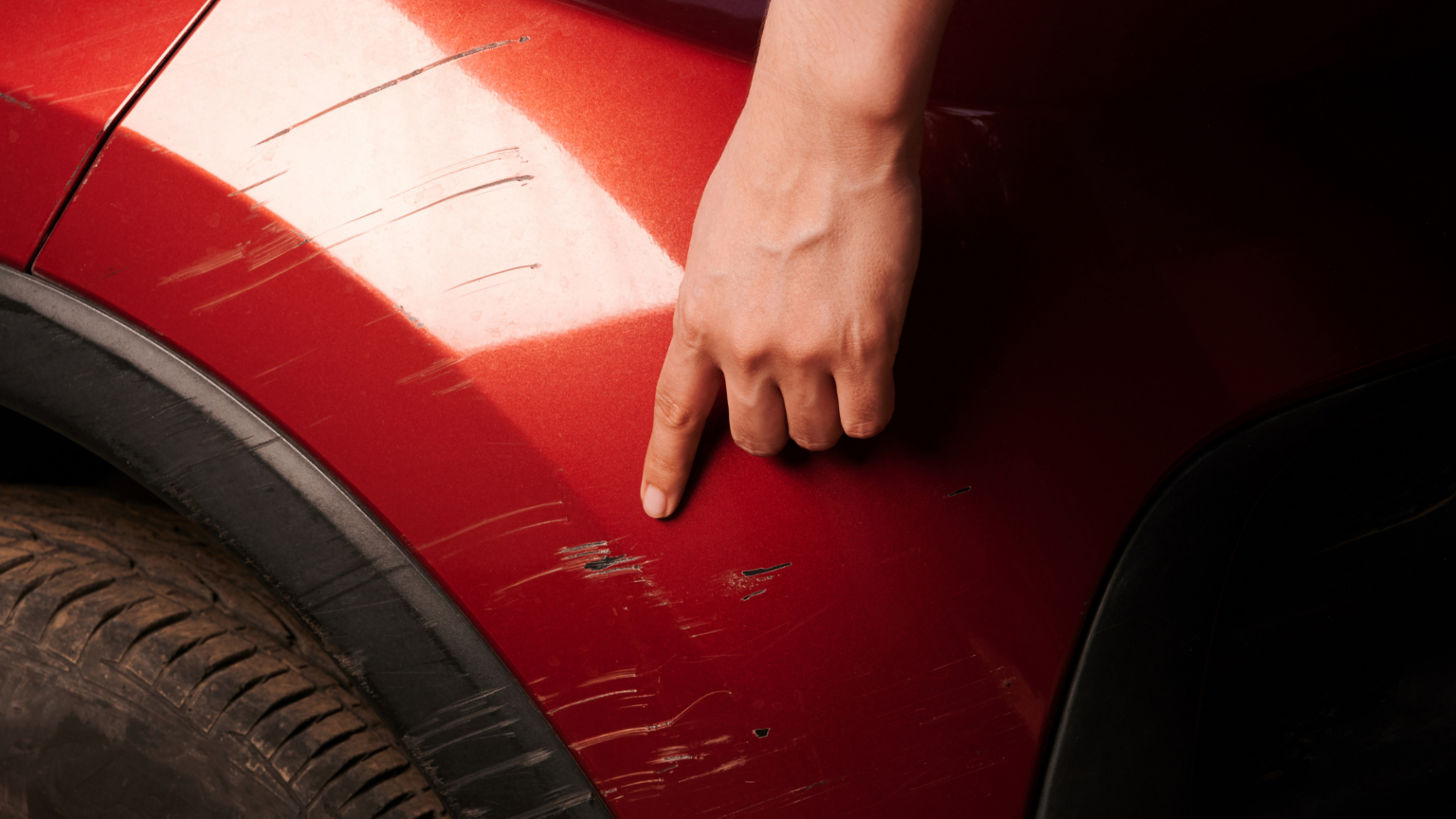Picture of red wheel trim with scratches on.
