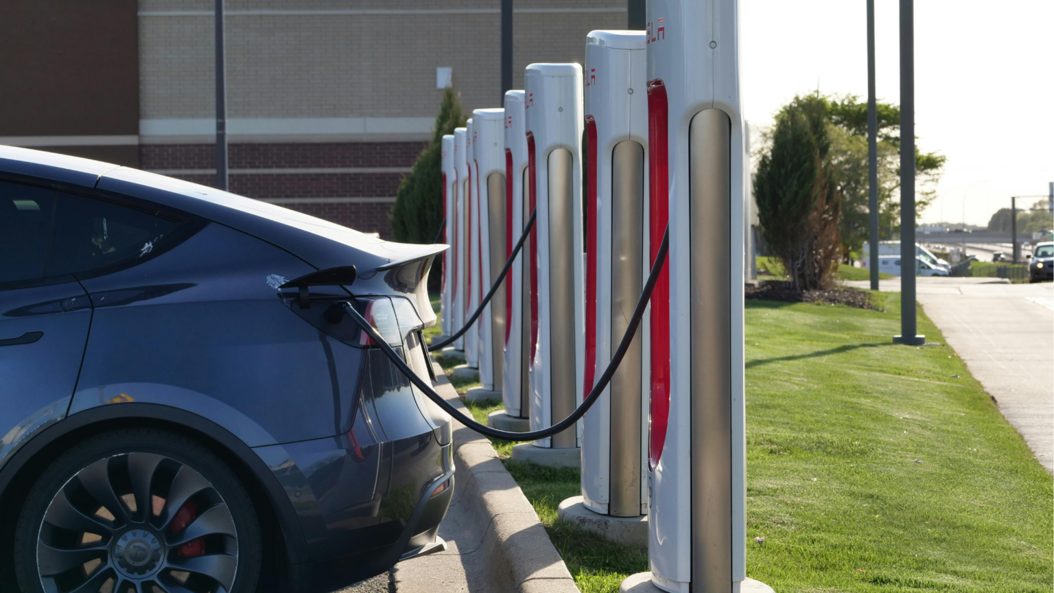 Car being charged at a public EV charging network.